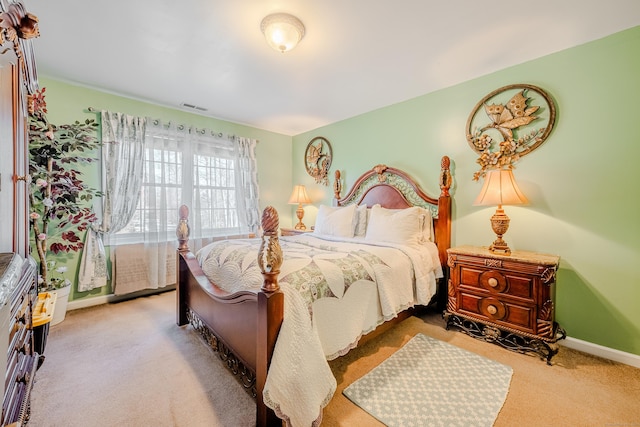 bedroom featuring carpet floors, visible vents, and baseboards