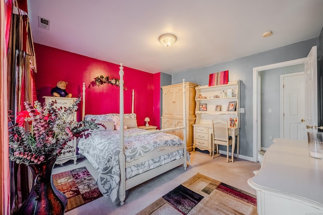 carpeted bedroom featuring visible vents and baseboards