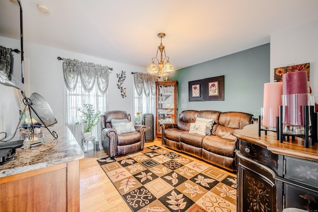 living room featuring light wood-style floors and a chandelier