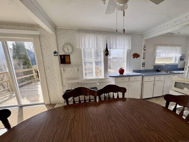 dining room featuring brick wall, ornamental molding, radiator heating unit, and a ceiling fan