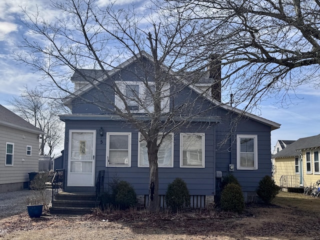 bungalow-style home with a chimney