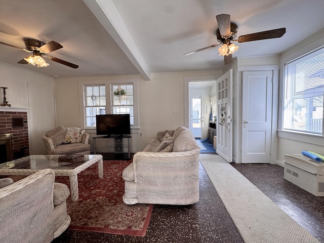 living area with crown molding, a fireplace, a ceiling fan, and beamed ceiling