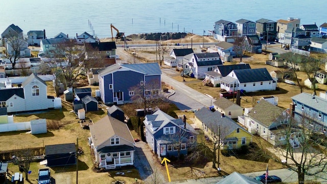 birds eye view of property with a water view and a residential view