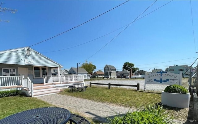 exterior space featuring covered porch and a residential view