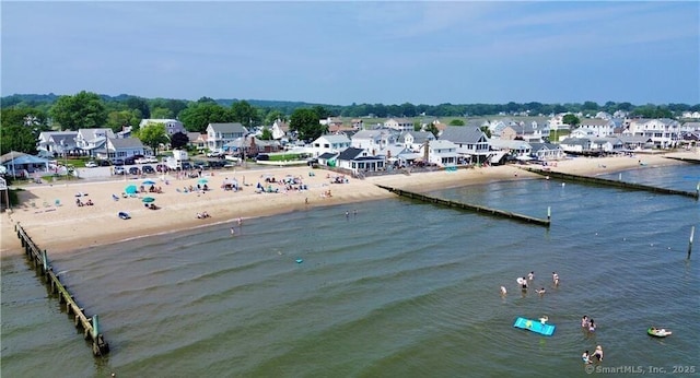 exterior space featuring a residential view, a water view, and a beach view