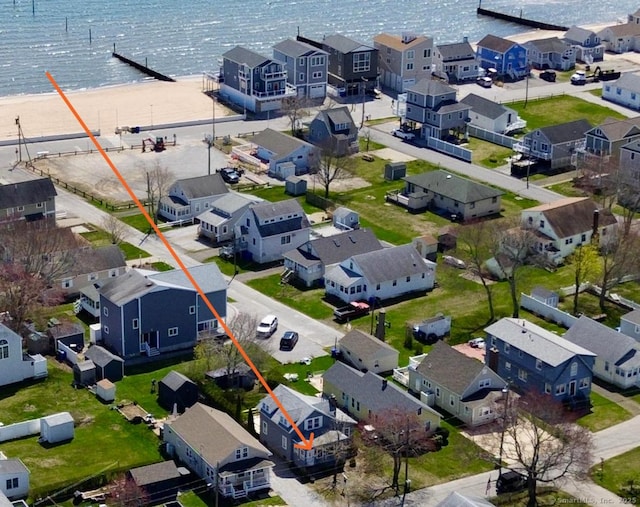 birds eye view of property with a residential view, a beach view, and a water view