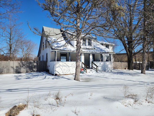 traditional-style home featuring a garage and fence