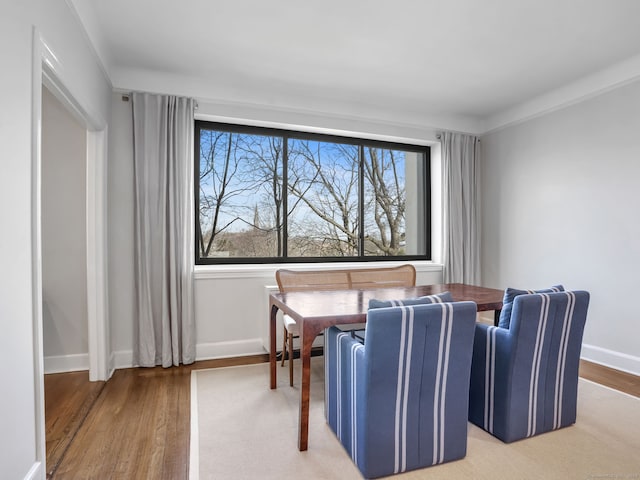 dining area with a wealth of natural light, baseboards, and wood finished floors