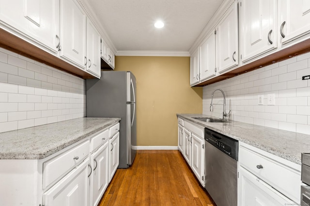 kitchen featuring a sink, stainless steel appliances, and white cabinetry