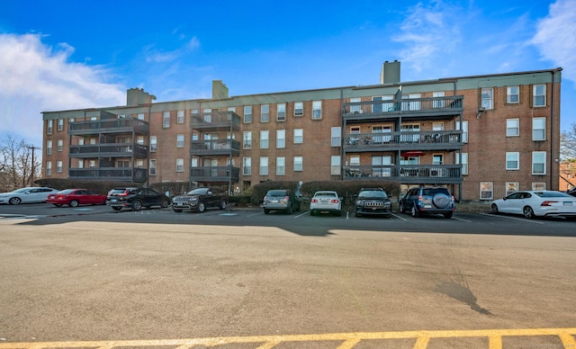 view of property featuring uncovered parking