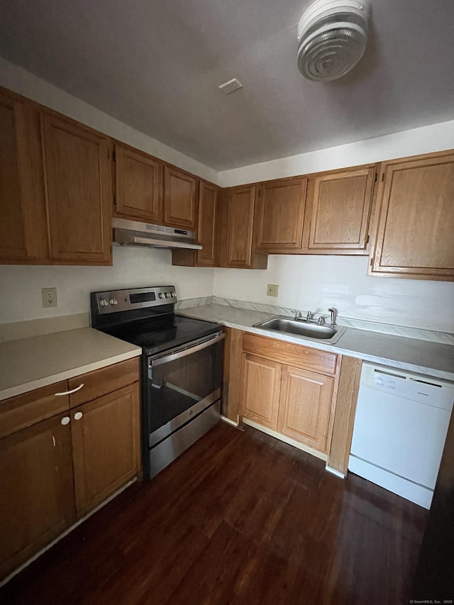 kitchen with light countertops, stainless steel range with electric cooktop, a sink, dishwasher, and under cabinet range hood