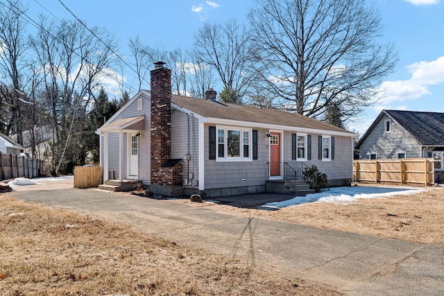 single story home with fence and a chimney