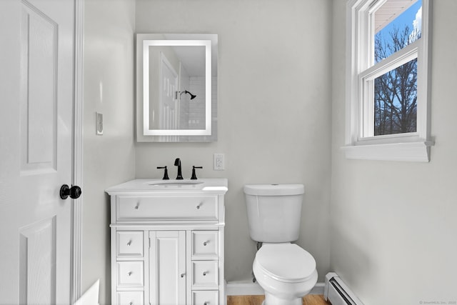 full bathroom with toilet, a baseboard radiator, baseboards, and vanity