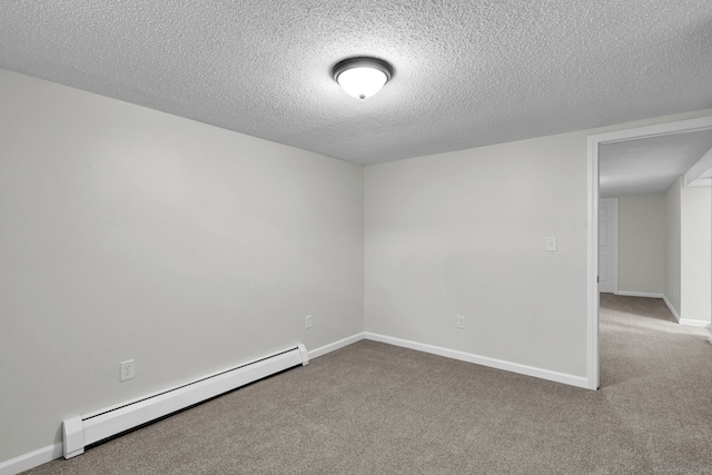 spare room with carpet, a textured ceiling, a baseboard radiator, and baseboards