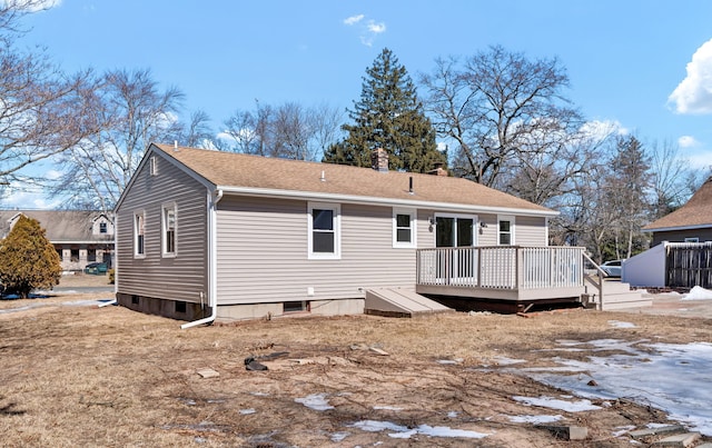 rear view of house with a chimney and a wooden deck