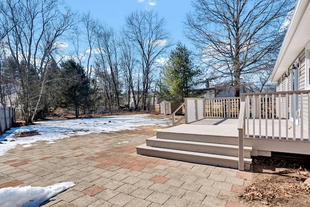 view of patio with a storage shed, a deck, and an outdoor structure