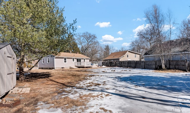 view of yard featuring an outbuilding, a shed, and fence