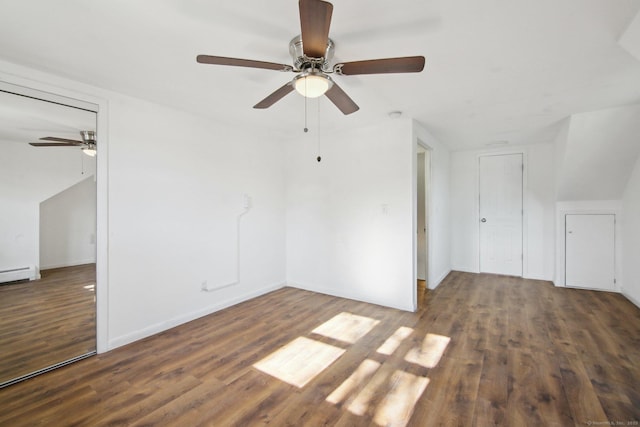 spare room with dark wood-style flooring and baseboards