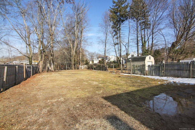 view of yard with a storage unit and fence private yard