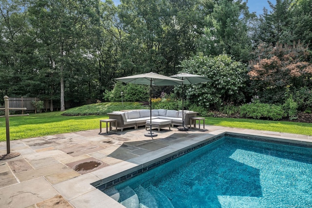 pool with a patio, a lawn, outdoor lounge area, and fence