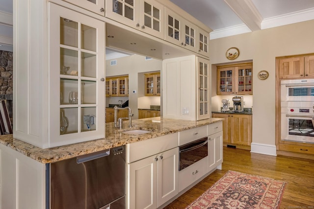 kitchen with crown molding, a warming drawer, appliances with stainless steel finishes, a sink, and wood finished floors