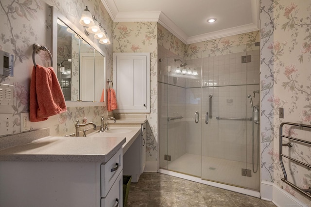 bathroom featuring ornamental molding, a shower stall, vanity, and wallpapered walls