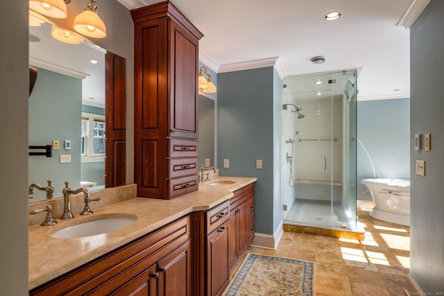 bathroom featuring double vanity, a stall shower, a sink, and crown molding