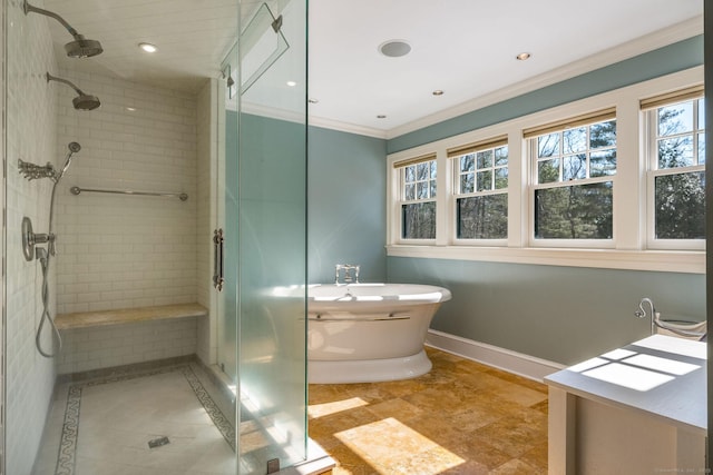 full bathroom with a freestanding tub, recessed lighting, baseboards, ornamental molding, and a shower stall