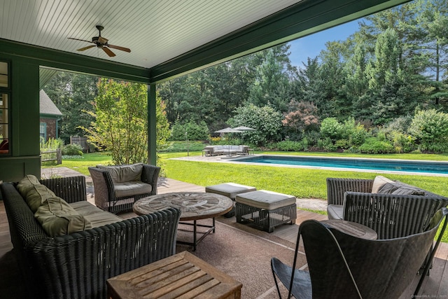 view of patio / terrace featuring ceiling fan, an outdoor living space, and an outdoor pool