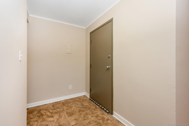 corridor with baseboards and crown molding