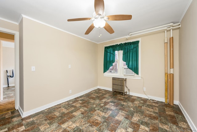 spare room with ornamental molding, radiator, and baseboards