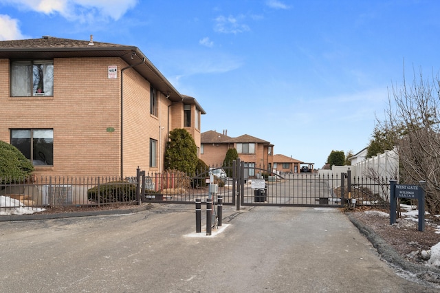 exterior space featuring a gated entry, a residential view, and a gate