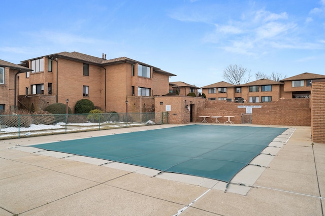 pool featuring a residential view, fence, and a patio