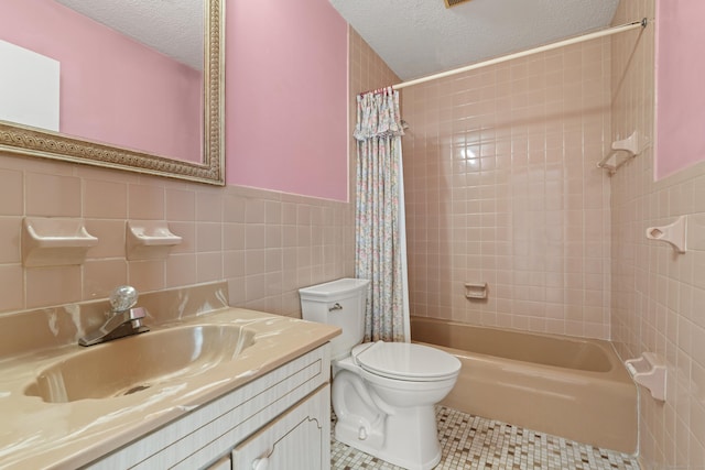 bathroom featuring tile patterned flooring, a textured ceiling, tile walls, and vanity