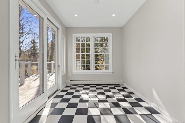 unfurnished sunroom with baseboard heating and a wealth of natural light