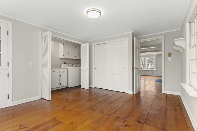 interior space with ornamental molding, hardwood / wood-style floors, and baseboards