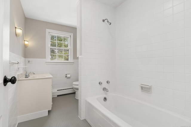 full bathroom with tile walls, a baseboard radiator, toilet, vanity, and tile patterned floors