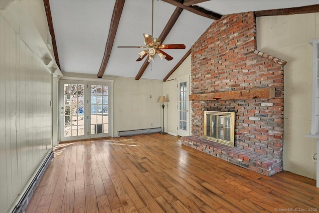 unfurnished living room featuring hardwood / wood-style flooring, a brick fireplace, a baseboard heating unit, and beam ceiling