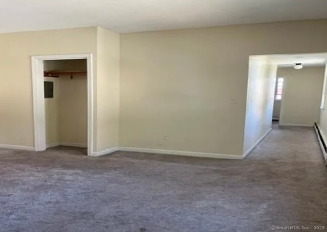 empty room featuring carpet floors and baseboards