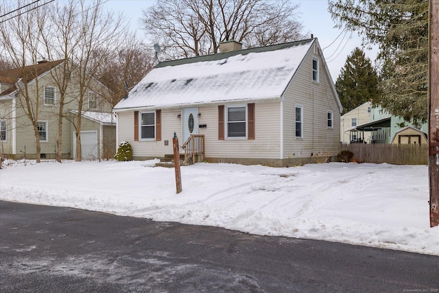 view of front of home featuring a detached garage and a chimney