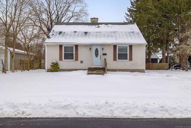 view of front of property featuring a chimney and fence