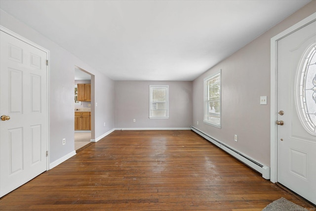 entrance foyer featuring baseboards, baseboard heating, and dark wood-type flooring