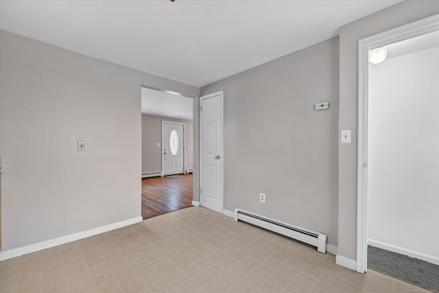 spare room featuring baseboards and baseboard heating