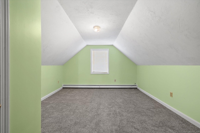 bonus room featuring carpet floors, a baseboard radiator, vaulted ceiling, a textured ceiling, and baseboards