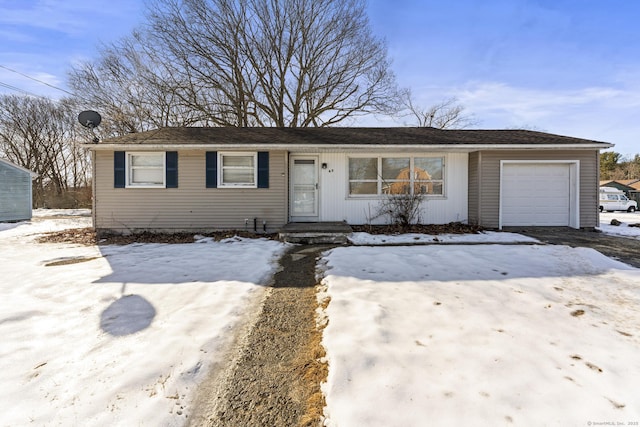 single story home featuring a garage and driveway