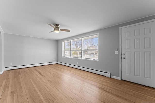 interior space with ceiling fan, a baseboard radiator, baseboards, and light wood-style flooring