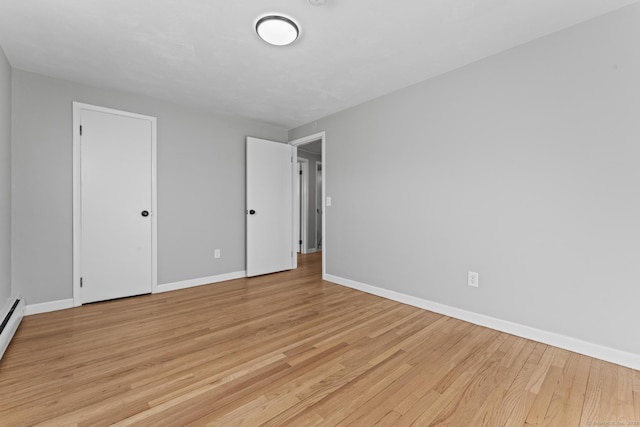 unfurnished bedroom with baseboards and light wood-style floors