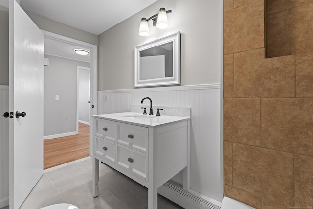 bathroom featuring a wainscoted wall, vanity, and tile patterned floors