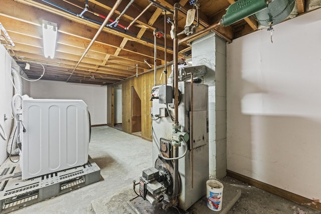 unfinished below grade area with washer / clothes dryer and baseboards