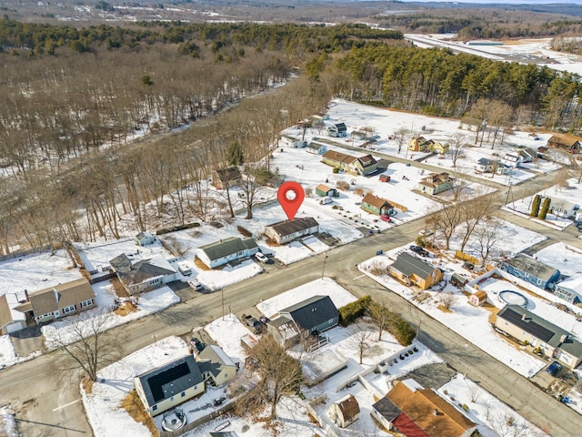 snowy aerial view with a residential view